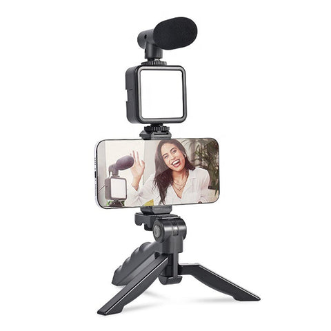 VYRO-7 vlogging kit with mini tripod, microphone, and LED light for video recording and content creation.