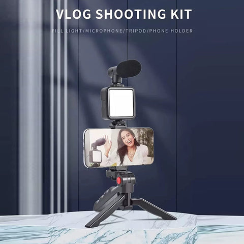 VYRO-7 vlogging kit with mini tripod, microphone, and LED light for video making, set up on a flat surface with accessories visible.